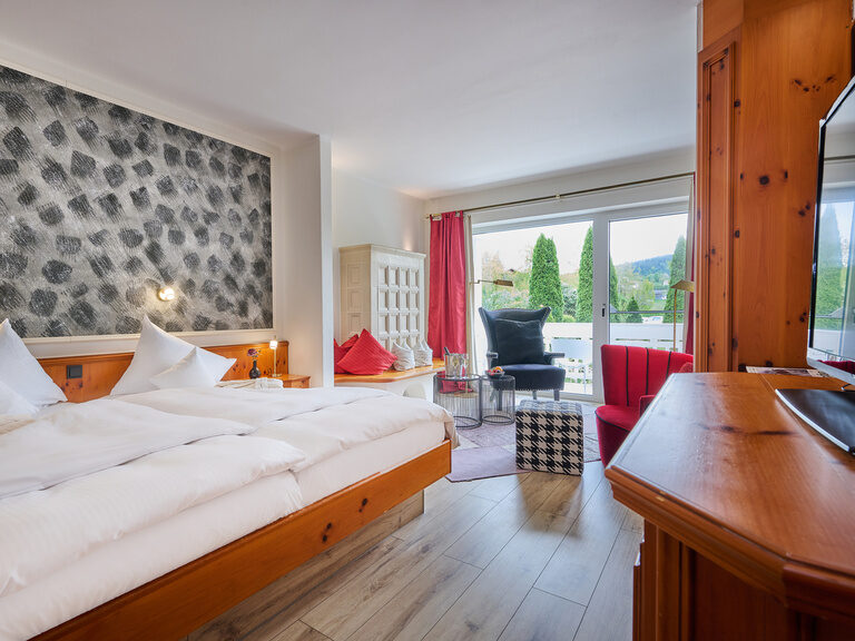 Modern eingerichtetes Hotelzimmer im Hotel Wutzschleife mit Balkon und Blick ins Grüne.